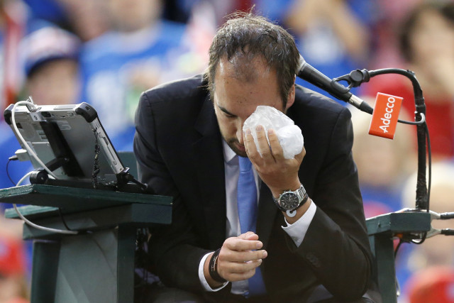 umpire arnaud gabas holds an ice pack to his eye after being struck by a ball photo reuters umpire arnaud gabas holds an ice pack to his eye after being struck by a ball photo reuters