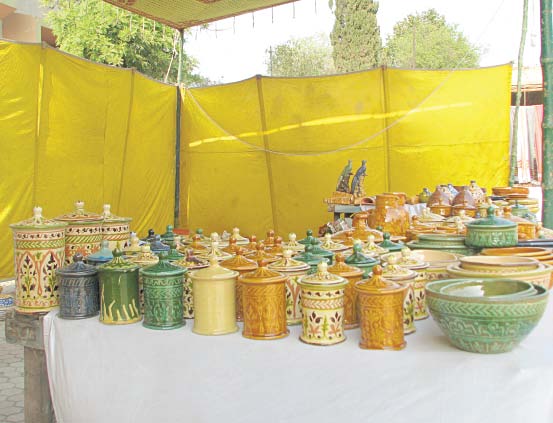 traditional handicrafts from sindh on display including magnificent lacquer art left and instantly recognisable sindhi caps featuring thari embroidery and rilli work right photos the express tribune