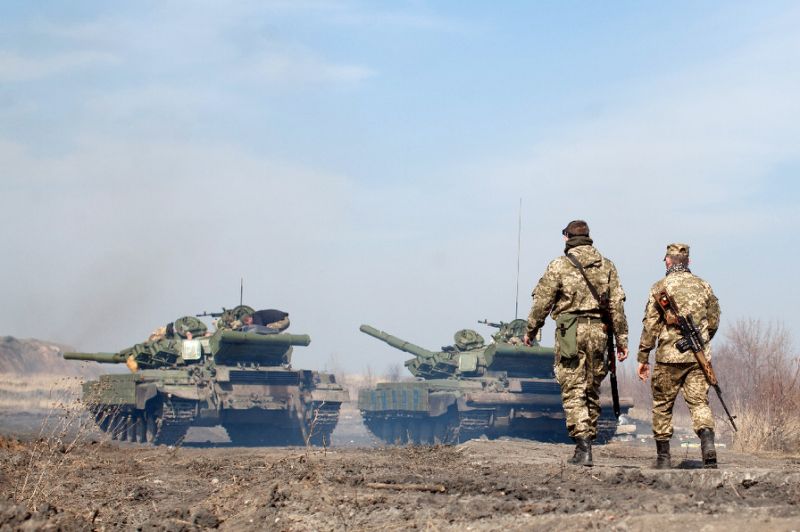 ukrainian servicemen walk behind tanks as they take part in exercises near the eastern ukrainian city photo afp