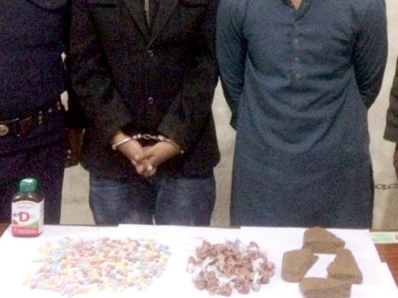 police display some of the seized ecstasy pills and hashish photo express