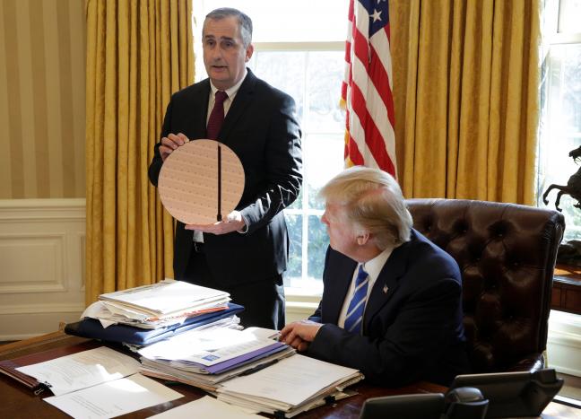 us president donald trump watches as chief executive officer of intel brian krzanich displays a silicon wafer for making chips in the oval office of the white house photo reuters