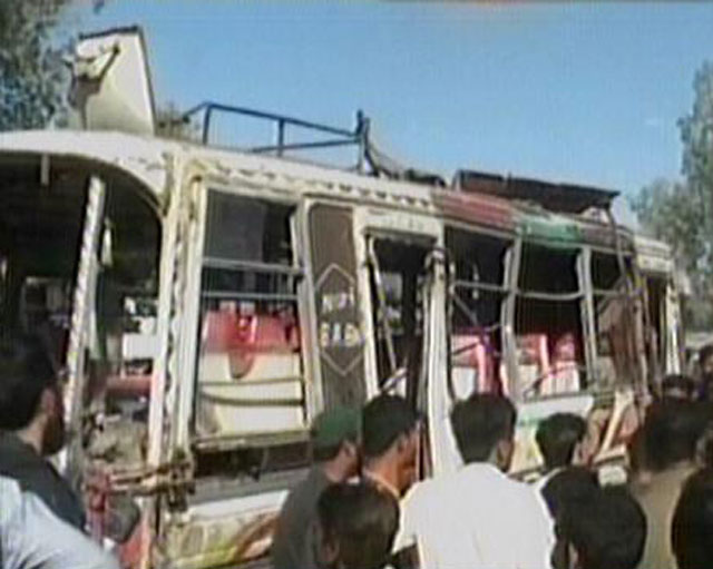 people gather around a bus which overturned on karachi 039 s university road on thursday february 9 2017 screengrab