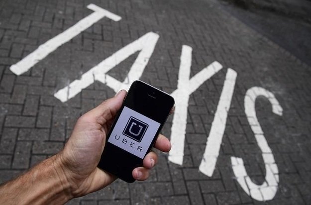 a photo illustration shows the uber app logo displayed on a mobile telephone as it is held up for a posed photograph in central london britain october 28 2016 photo reuters