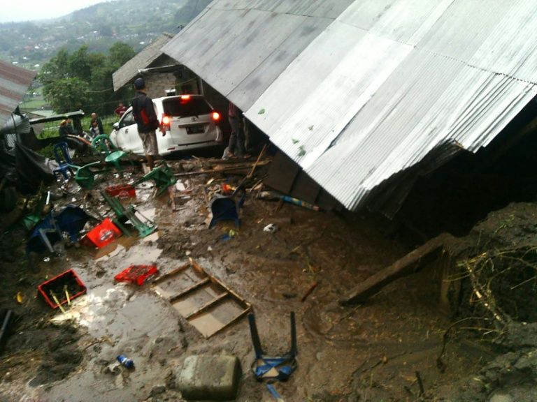 villagers attempt to salvage their belongings from a house damaged in a landslide in kintamani bali province photo afp