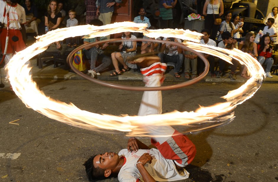 traditional dancers and musicians perform in a procession in front of the gangarama temple photo afp