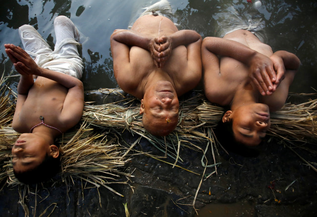devotees offer prayers by submerging themselves in the hanumante river during the swasthani brata katha festival in bhaktapur nepal photo reuters devotees offer prayers by submerging themselves in the hanumante river during the swasthani brata katha festival in bhaktapur nepal photo reuters