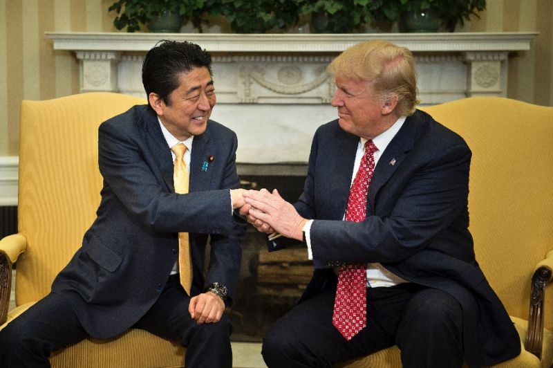 us president donald trump praised japanese prime minister shinzo abe 039 s quot strong hands quot after greeting him with a hug at the white house photo afp