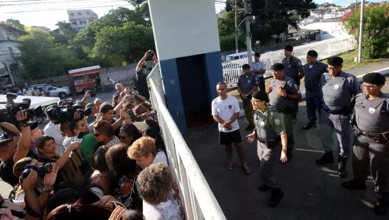 a military police officer r talks with relatives of police officers who are blocking the main entrance of police headquarters during a police strike over wages in vitoria espirito santo brazil february 11 2017 photo reuters a military police officer r talks with relatives of police officers who are blocking the main entrance of police headquarters during a police strike over wages in vitoria espirito santo brazil february 11 2017 photo reuters