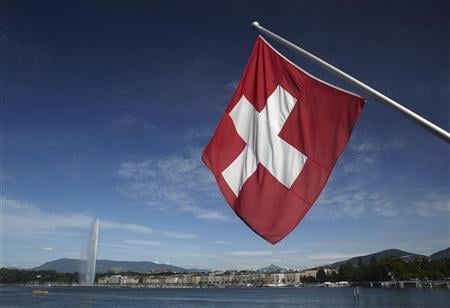 a swiss flag is pictured next to the jet d 039 eau water fountain and the lake leman from the st pierre cathedrale in geneva june 5 2012 photo reuters