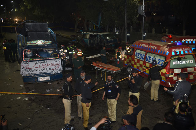 police stand alert as they secure the site of a bomb explosion in lahore on february 13 2017 photo afp