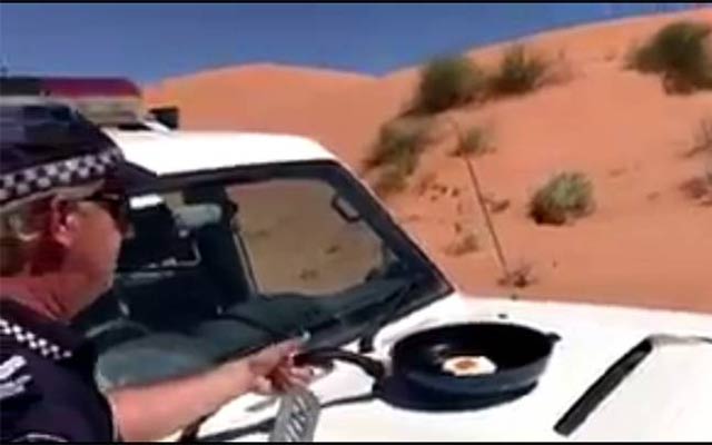 video of an australian police officer frying an egg on the bonnet of his patrol vehicle has gone viral on social media screengrab