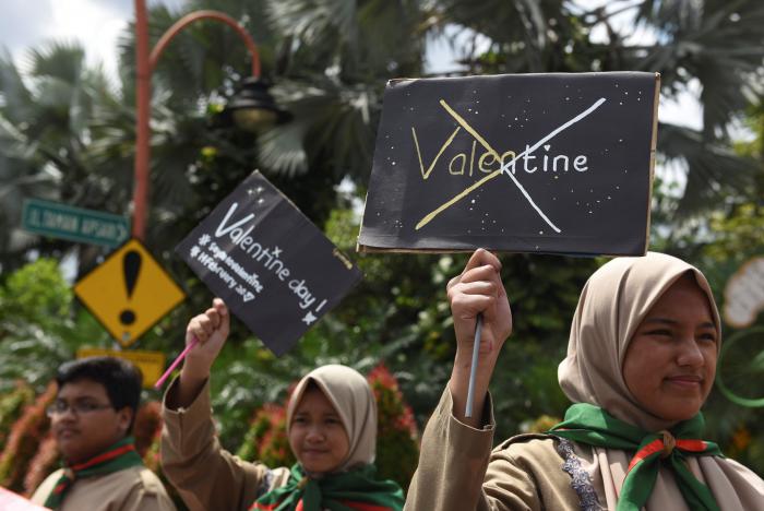 muslim students hold posters during a protest against valentine 039 s day celebrations in surabaya indonesia february 13 2017 photo reuters