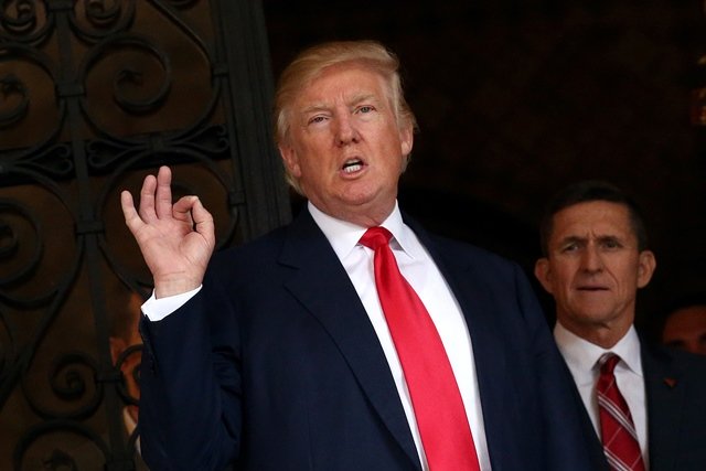 u s president elect donald trump talks to members of the media as retired u s army lieutenant general michael flynn stands next to him at mar a lago estate photo reuters