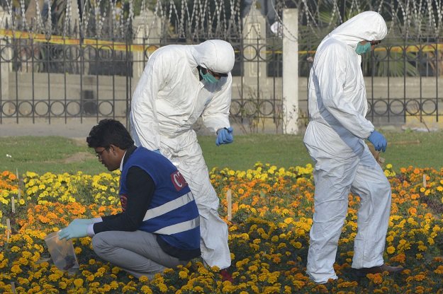 security officials collect evidence at the site of a suicide bombing in lahore on february 14 2017 photo afp