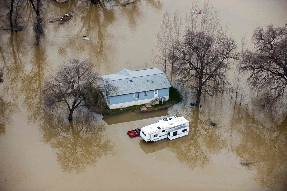 a home is seen marooned as the surrounding property is submerged in floodwater in oroville california photo afp