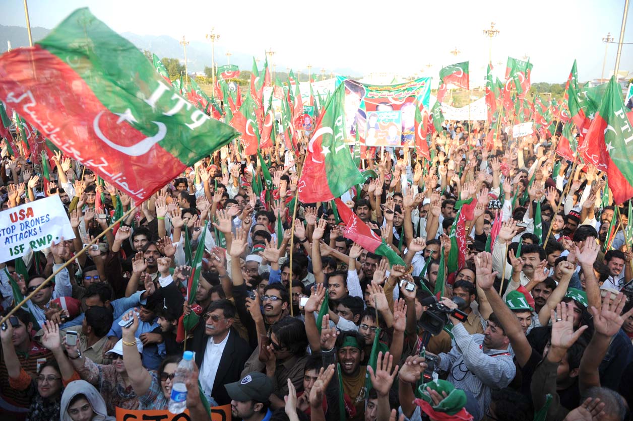 supporters of the pakistani politician imran khan and chief of tehreek e insaf movement for justice party shout slogans during protest rally in islamabad on october 28 2011 against the us drone attacks in pakistani tribal region photo afp