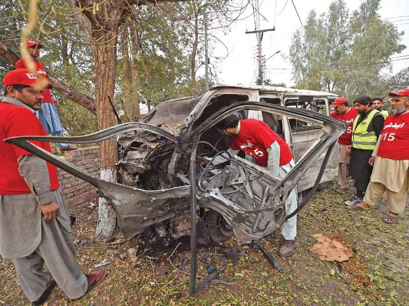 volunteers inspect the mangled heap of a van targeted in the peshawar suicide attack a photo of the three levies men killed in the mohmand bombings photo afp express volunteers inspect the mangled heap of a van targeted in the peshawar suicide attack a photo of the three levies men killed in the mohmand bombings photo afp express