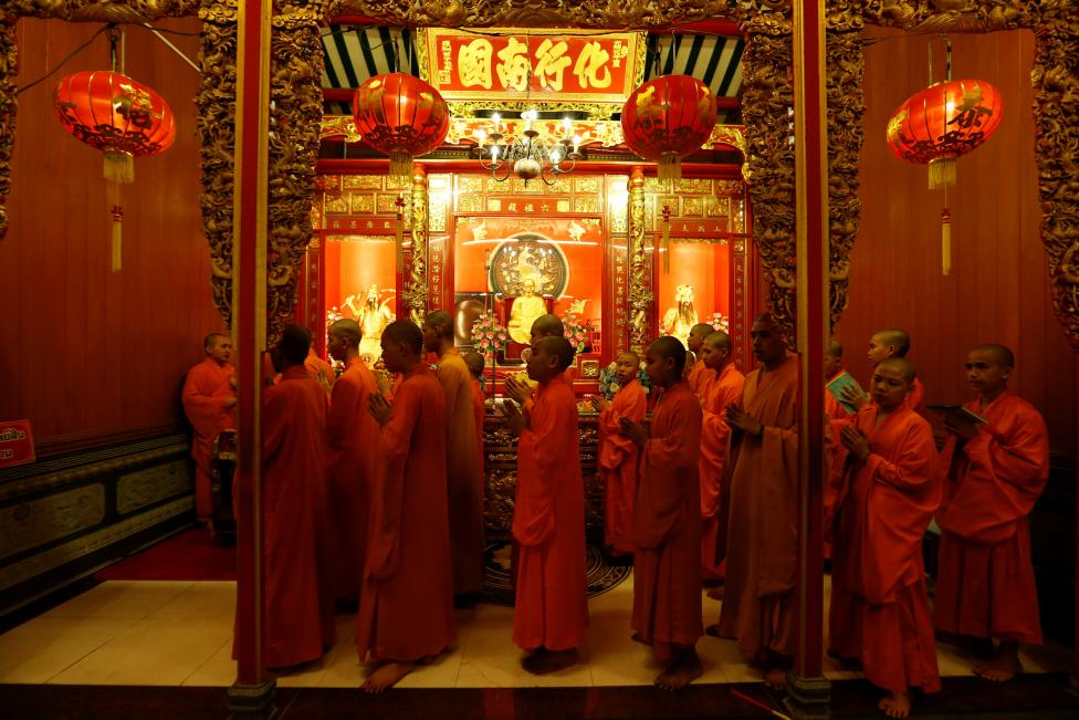 buddhist monks pray inside a temple during the lunar new year 039 s eve celebrations in chinatown in bangkok thailand reuters jorge silva