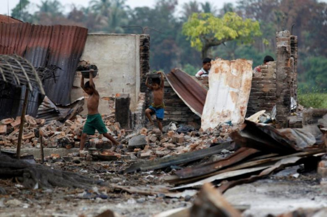 children recycle goods from the ruins of a market which was set on fire at a rohingya village outside maugndaw in rakhine state myanmar october 27 2016 photo reuters children recycle goods from the ruins of a market which was set on fire at a rohingya village outside maugndaw in rakhine state myanmar october 27 2016 photo reuters