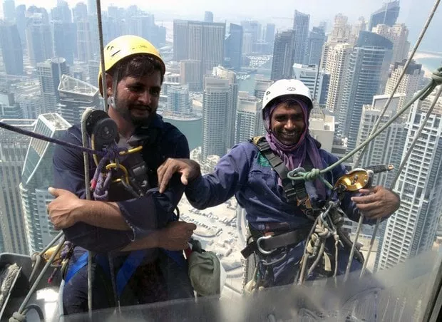 pakistani window cleaners work on a building in the gulf emirate of dubai on 6 september 2014 photo afp pakistani window cleaners work on a building in the gulf emirate of dubai on 6 september 2014 photo afp