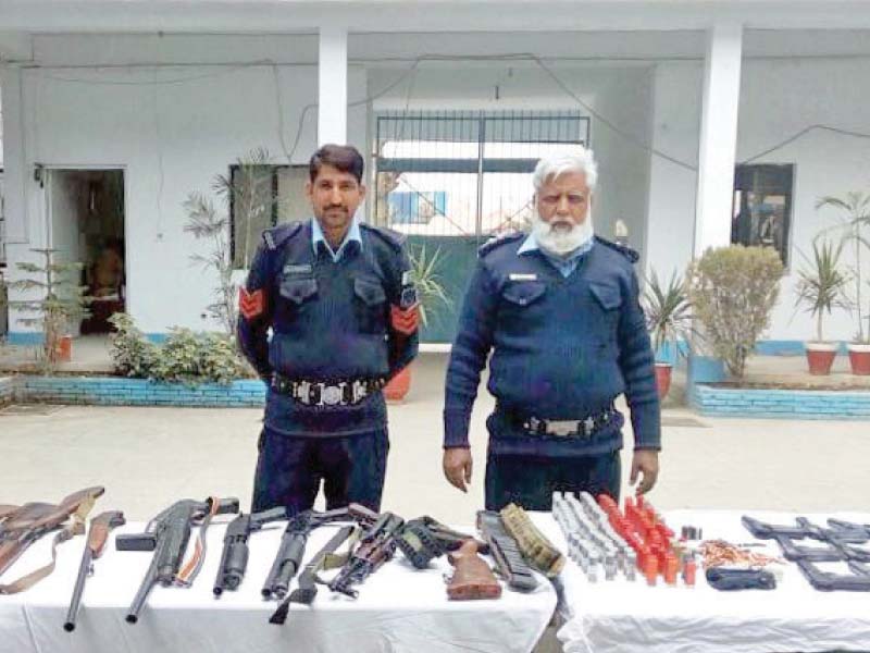 policemen with seized arms and ammunition photo inp