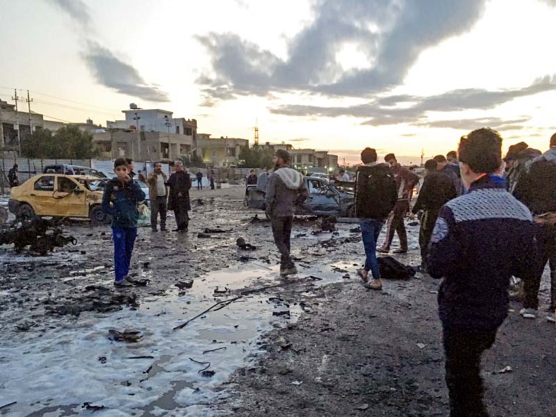 iraqis sift through debris at the scene of the massive car bombing in baghdad photo afp