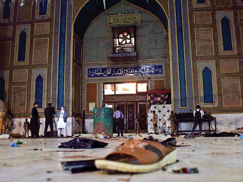 belongings of the victims of the suicide attack lie scattered on the floor of the sehwan shrine photo afp