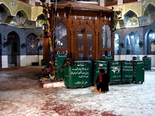 a devotee sits on the blood stained floor a day after a bomb attack hit the 13th century sufi shrine of lal shahbaz qalandar in the town of sehwan in sindh on february 17 2017 photo afp