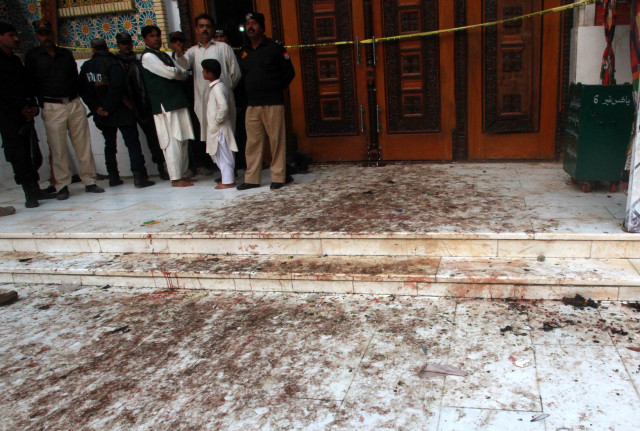 policemen stand guard at outside lal shahbaz shrine to stop the devotees from entering the premises photo athar khan