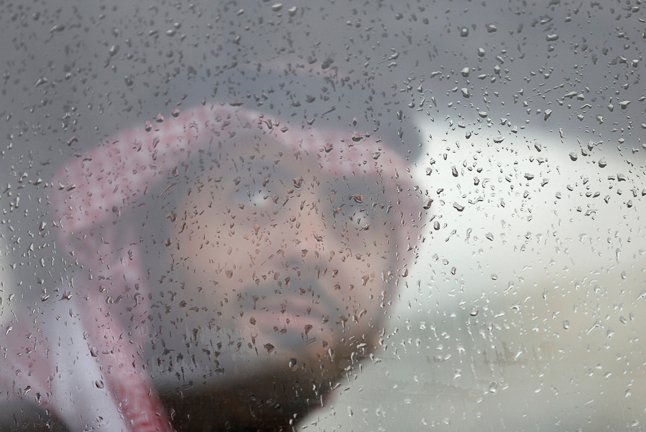 a saudi man looks out of a window during rain in riyadh saudi arabia reuters
