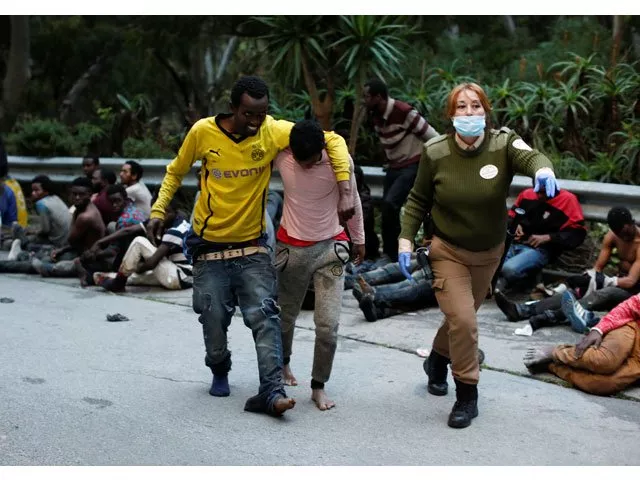 african migrants help each other as they arrive at the ceti the short stay immigrant centre after crossing the border from morocco to spain 039 s north african enclave of ceuta spain february 17 2017 photo reuters african migrants help each other as they arrive at the ceti the short stay immigrant centre after crossing the border from morocco to spain 039 s north african enclave of ceuta spain february 17 2017 photo reuters