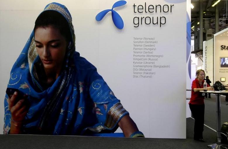 a visitor rests under a telenor group sign at the gsma mobile world conference in barcelona spain february 18 2009 photo reuters