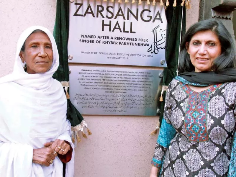 lok virsa executive director dr fouzia saeed and pushto singer zarsanga jan stand in front of the plaque of the hall named after her photo express lok virsa executive director dr fouzia saeed and pushto singer zarsanga jan stand in front of the plaque of the hall named after her photo express