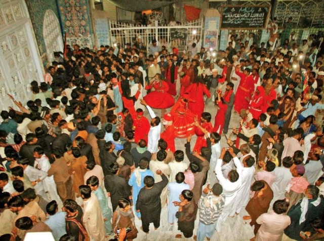 devotees perform dhamaal at the sehwan shrine a day after the blast photo athar khan express devotees perform dhamaal at the sehwan shrine a day after the blast photo athar khan express