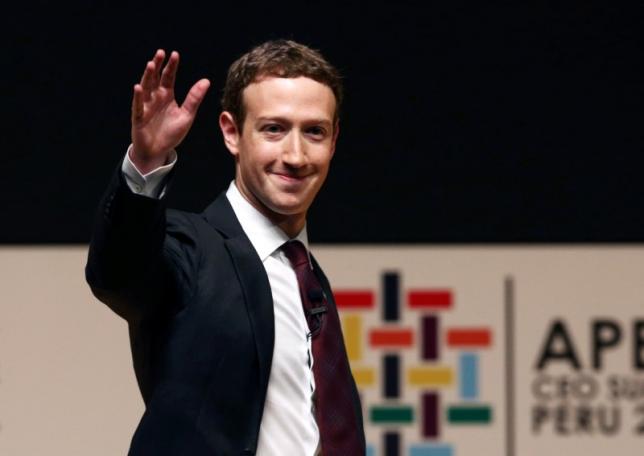 facebook founder mark zuckerberg waves to the audience during a meeting of the apec photo afp
