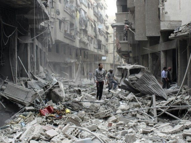 people walk amid the rubble following reported air strikes by syrian regime forces on may 14 2015 on the rebel held town of ain tarma east of the capital damascus photo afp people walk amid the rubble following reported air strikes by syrian regime forces on may 14 2015 on the rebel held town of ain tarma east of the capital damascus photo afp