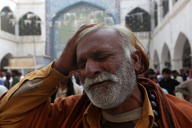 a man beats his head as he mourns the death of a relative who was killed in a suicide blast at the tomb of sufi saint syed usman marwandi also known as the lal shahbaz qalandar shrine on thursday evening in sehwan sharif pakistan 039 s southern sindh province february 17 2017 reuters