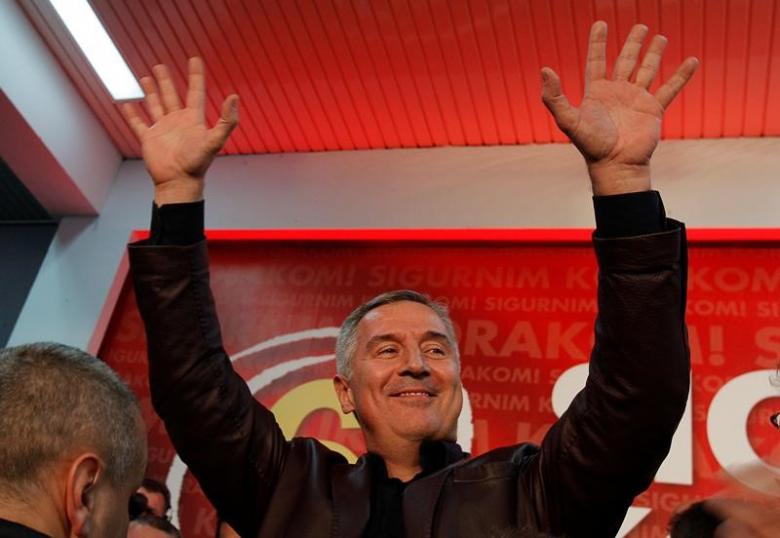 montenegrin prime minister and leader of ruling democratic party of socialist milo djukanovic wave to supporters after the parliamentary elections in podgorica montenegro october 17 2016 photo reuters