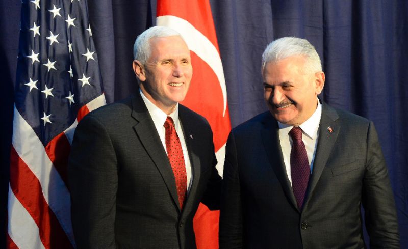 us vice president michael richard pence l and turkish prime minister binali yildirim pose for photographers ahead talks at the munich security conference photo afp