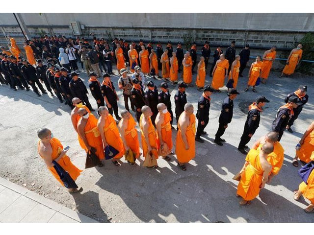 policemen and buddhist monks walk inside dhammakaya temple to search for a fugitive buddhist monk in pathum thani province thailand february 17 2017 photo reuters policemen and buddhist monks walk inside dhammakaya temple to search for a fugitive buddhist monk in pathum thani province thailand february 17 2017 photo reuters