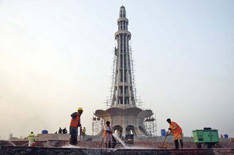 labourers clean the platform of minar e pakistan photo express