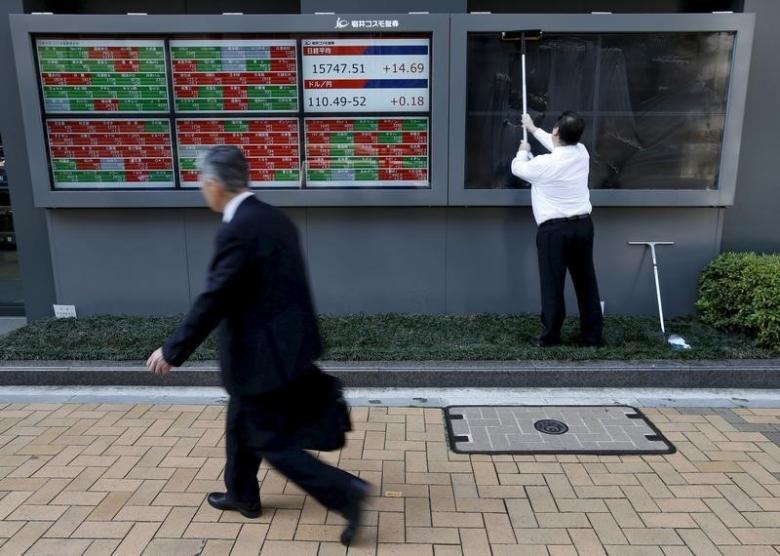 a man r cleans electronic boards showing japan 039 s nikkei average the exchange rate between the japanese yen against the u s dollar and stock quotation outside a brokerage in tokyo japan in this april 6 2016 file photo reuters issei kato files