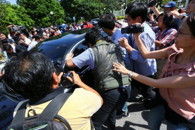 members of the media chase a north korean official car to ask questions at the foreign ministry in putrajaya malaysia february 20 2017 photo reuters