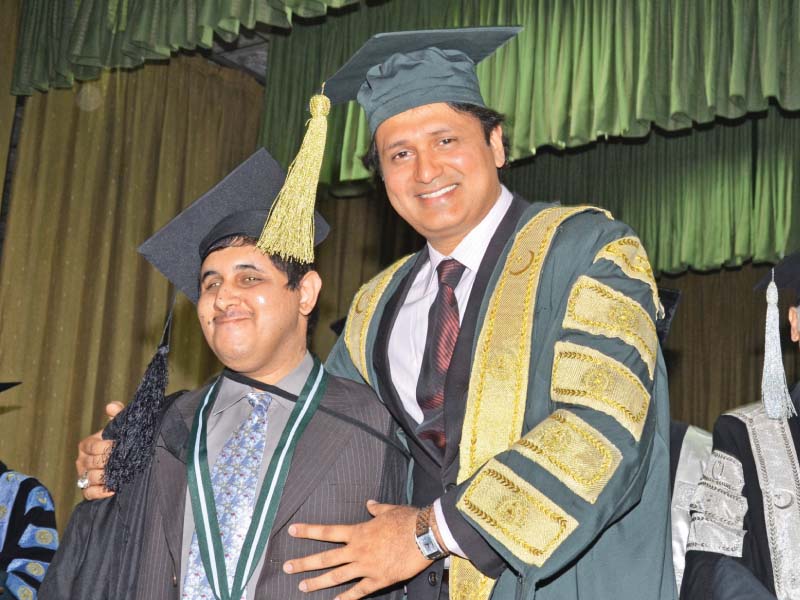 punjab higher education minister syed raza ali gillani awards gold medal to a visually impaired student muhammad ahmad photo abid nawaz express