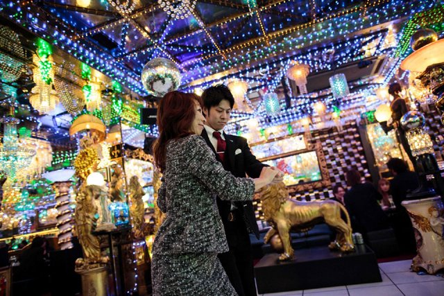 a woman dances with a male host at a host club in the kabukicho red light district in tokyo on jan 27 2017 photo afp