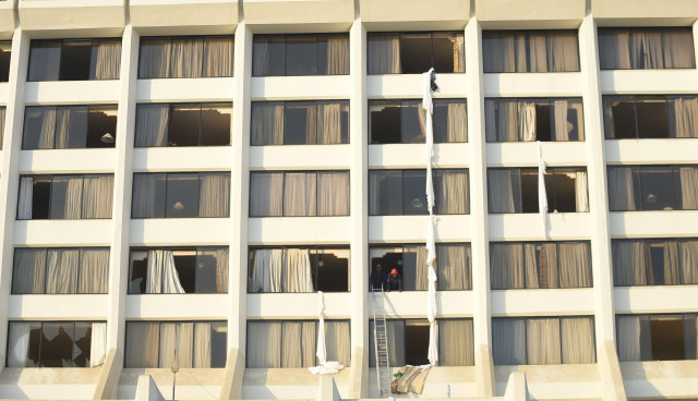 firefighters look from a room of regent plaza hotel following a fire on december 5 2016 which claimed 11 lives photo afp firefighters look from a room of regent plaza hotel following a fire on december 5 2016 which claimed 11 lives photo afp
