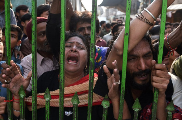 devotees gather outside closed gate of lal shahbaz qalandar shrine after a suicide attack killed over 80 people photo afp devotees gather outside closed gate of lal shahbaz qalandar shrine after a suicide attack killed over 80 people photo afp