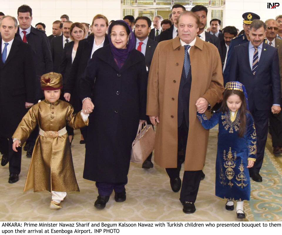 pm nawaz and his wife begum kulsoom nawaz are escorted by the turkish children who presented them bouquets upon arrival in ankara photo inp