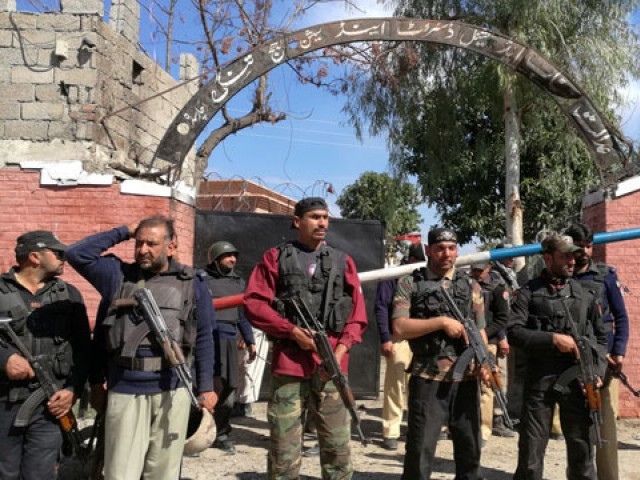 policemen stand guard at a courthouse after an attack by suicide bombers in charsadda on tuesday february 21 2017 photo reuters