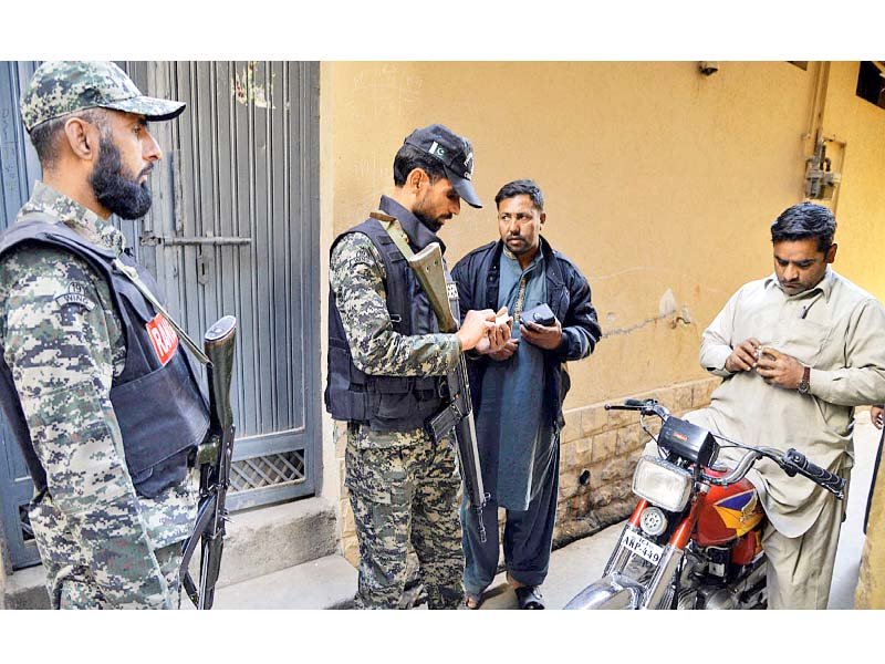 rangers personnel check documents of people during door to door checking in dhoke mangta photo online